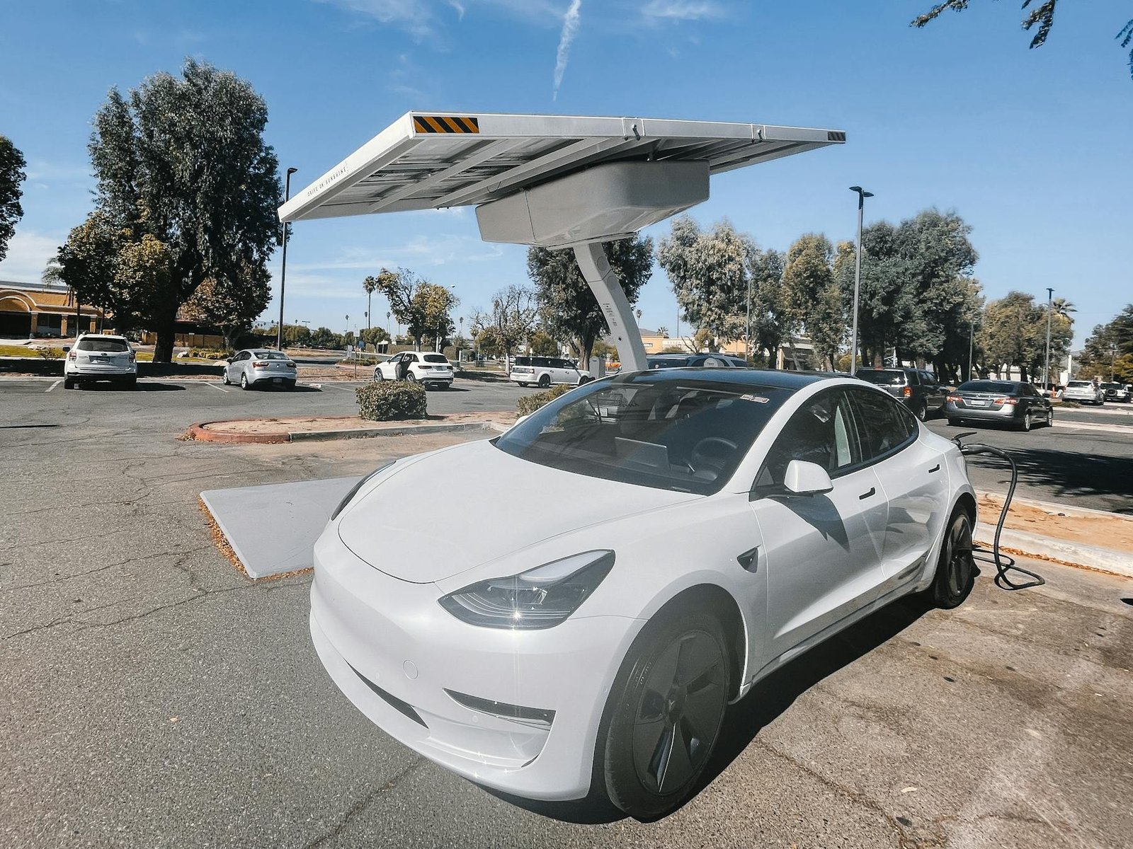 Electric vehicle charging at a solar-powered charging station.